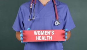 Women's Health sign held by nurse
