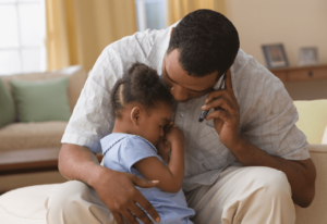 Father comforting child with repiratory infection